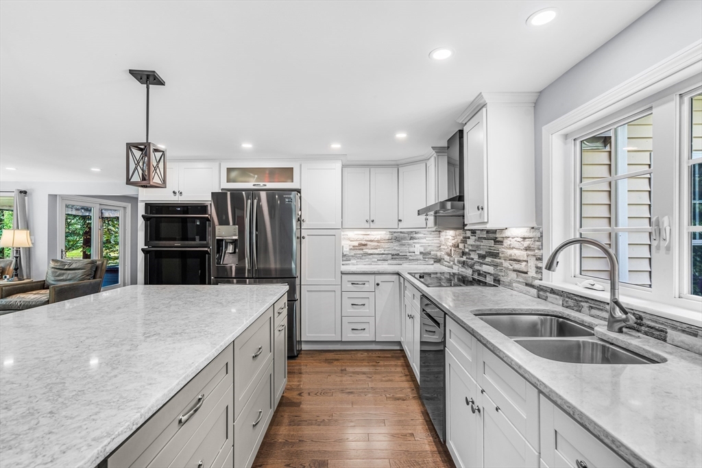 121 Shade Street Lexington, MA 02421 - Photo 9 of 42 a kitchen with stainless steel appliances granite countertop a sink stove and refrigerator