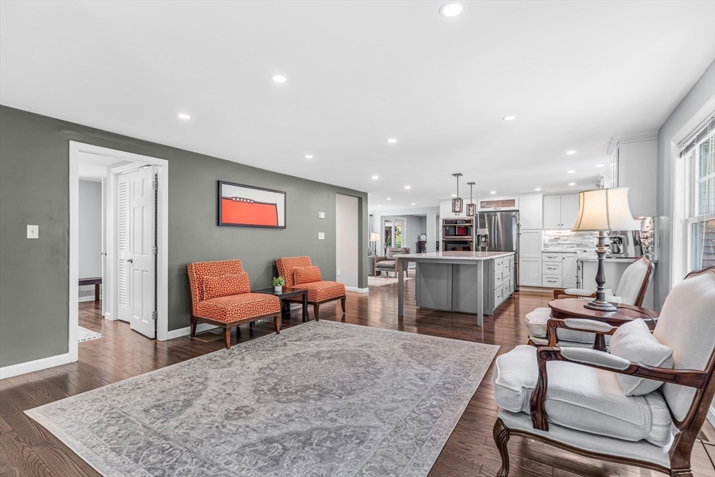 121 Shade Street Lexington, MA 02421 - Photo 10 of 42 a living room with couches chairs and kitchen view with wooden floor