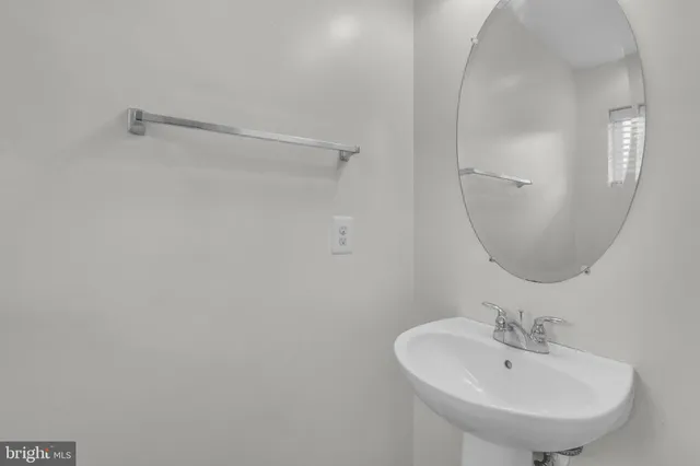 a bathroom with a sink a mirror and a shower