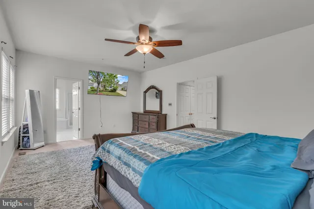 a bedroom with a bed and a dresser with the potted plants