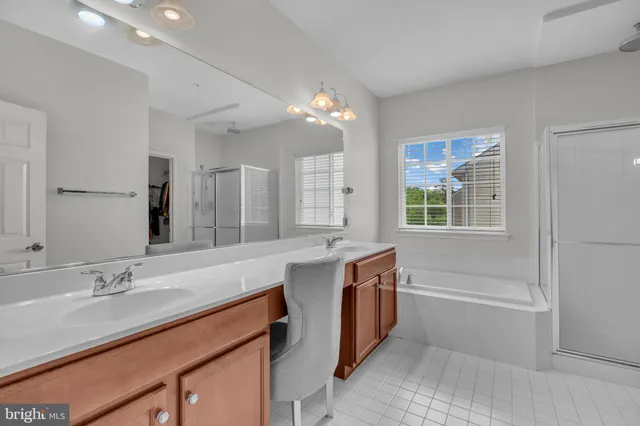 a bathroom with a sink double vanity granite tub and shower