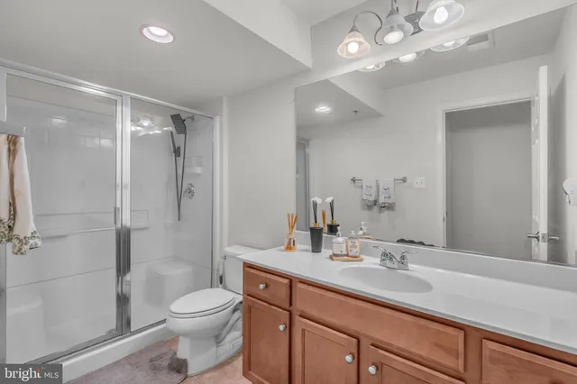 a bathroom with a toilet a sink and a large mirror