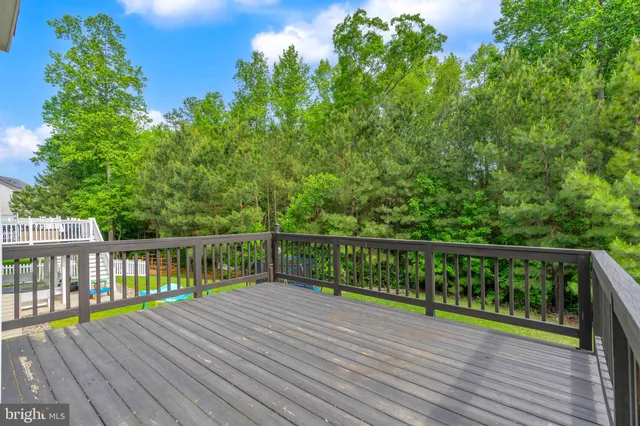 a view of balcony with wooden floor and fence
