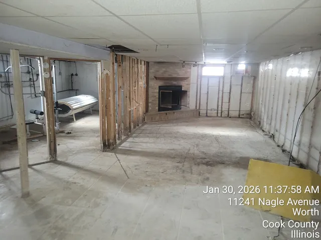 a view of a hallway with a table and chairs