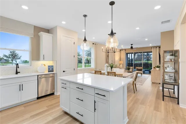 a large kitchen with kitchen island a large island in it