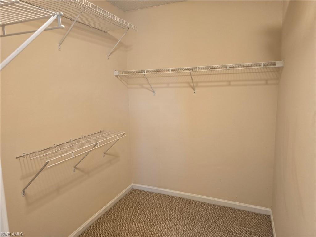 5741 Whitaker Road, Unit D203 Naples, FL 34112 - Photo 11 of 30 a view of a room with racks on the wall