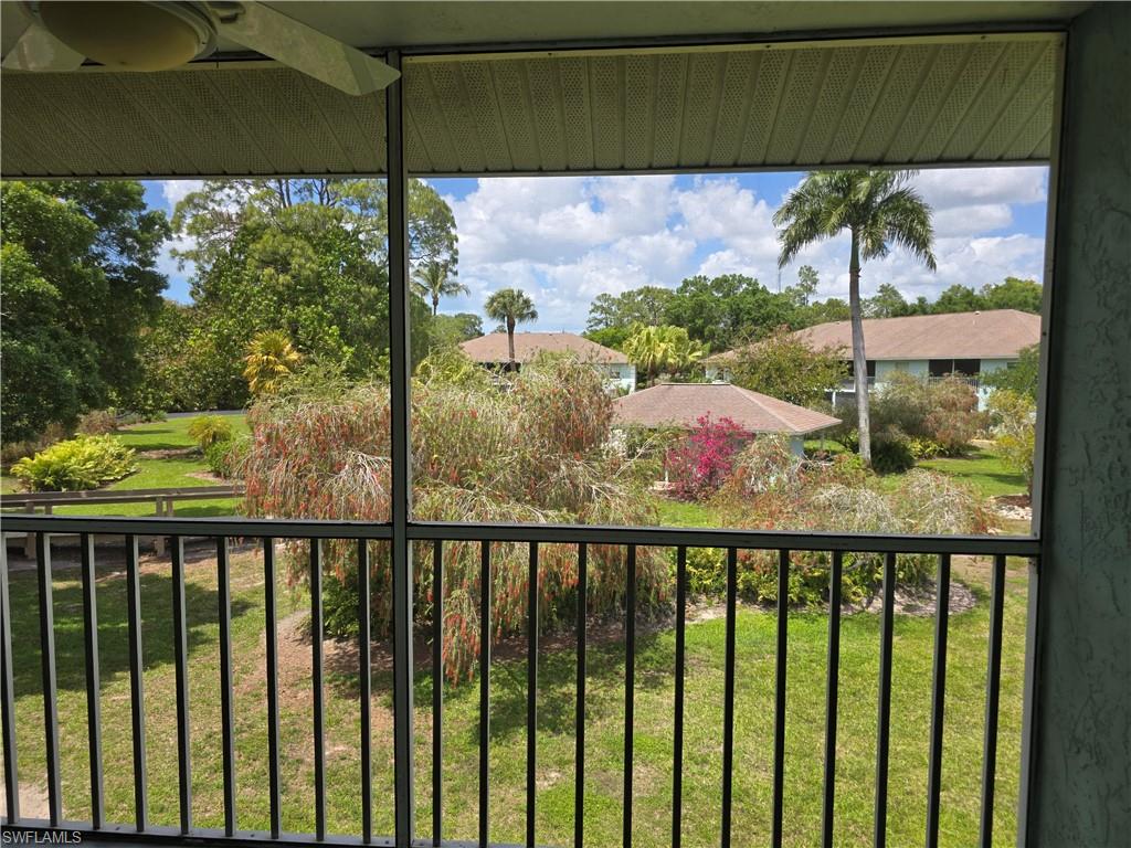 5741 Whitaker Road, Unit D203 Naples, FL 34112 - Photo 22 of 30 a view of a porch and a yard