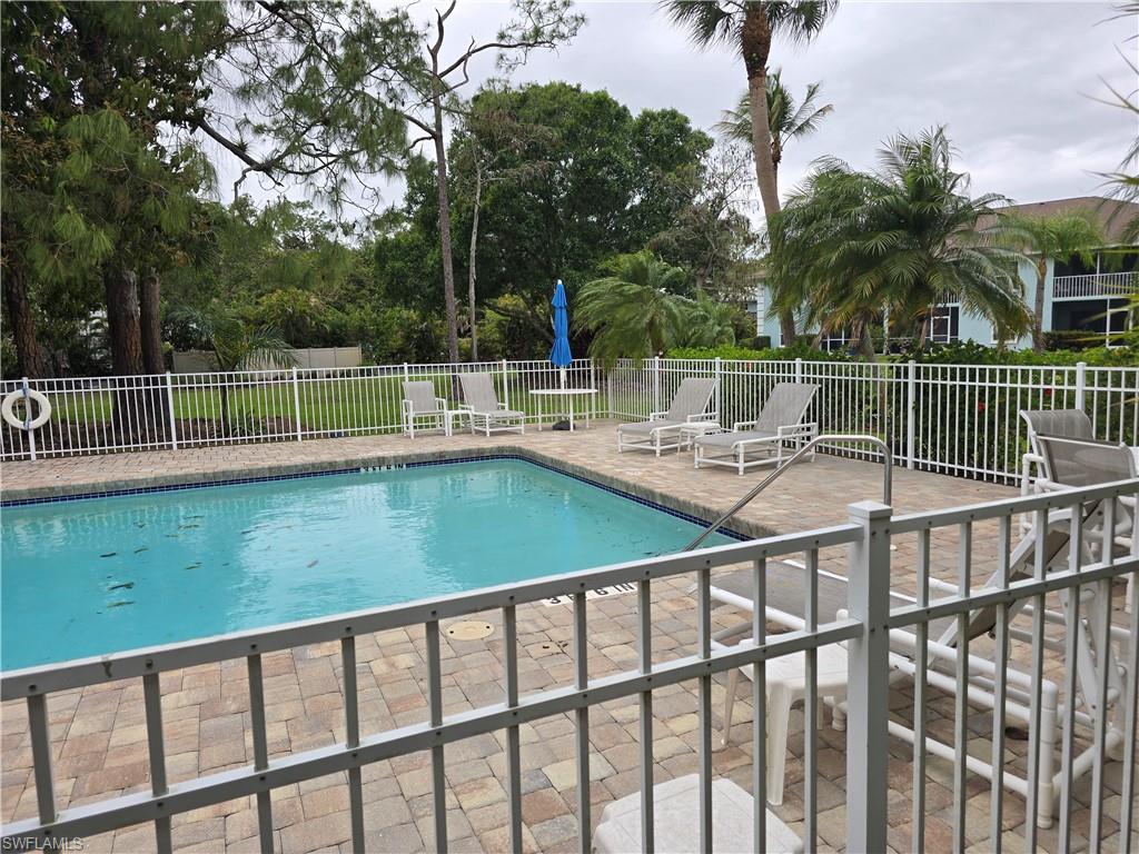 5741 Whitaker Road, Unit D203 Naples, FL 34112 - Photo 26 of 30 a view of a patio with a lake view