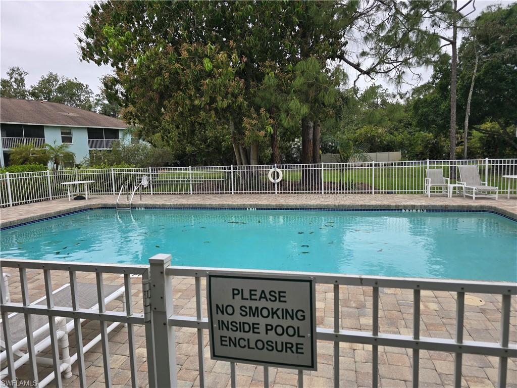 5741 Whitaker Road, Unit D203 Naples, FL 34112 - Photo 27 of 30 a view of a house with a yard from a large window