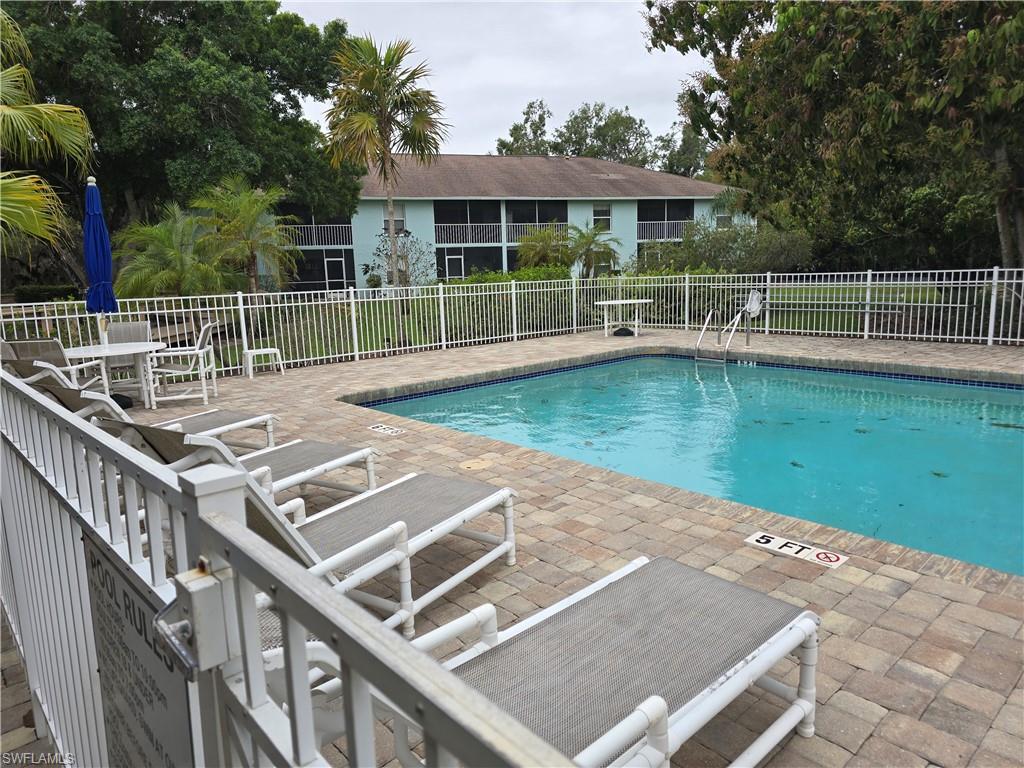 5741 Whitaker Road, Unit D203 Naples, FL 34112 - Photo 28 of 30 a view of a house with a backyard