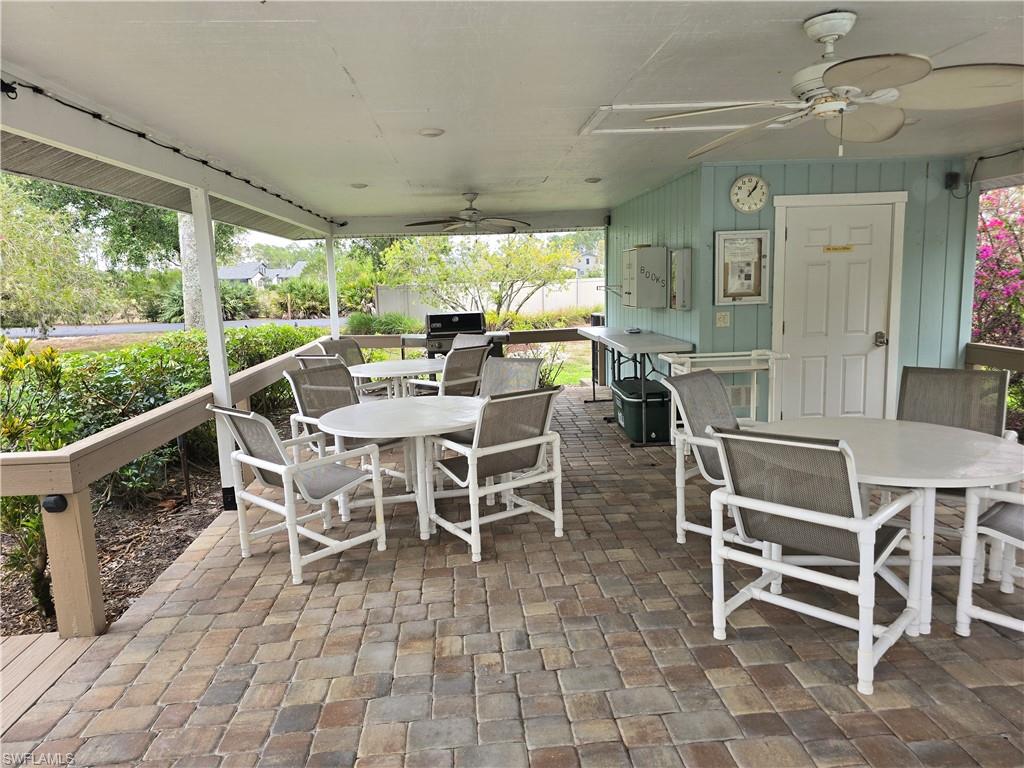 5741 Whitaker Road, Unit D203 Naples, FL 34112 - Photo 29 of 30 View of patio at pool with outdoor BBQ and dining space.