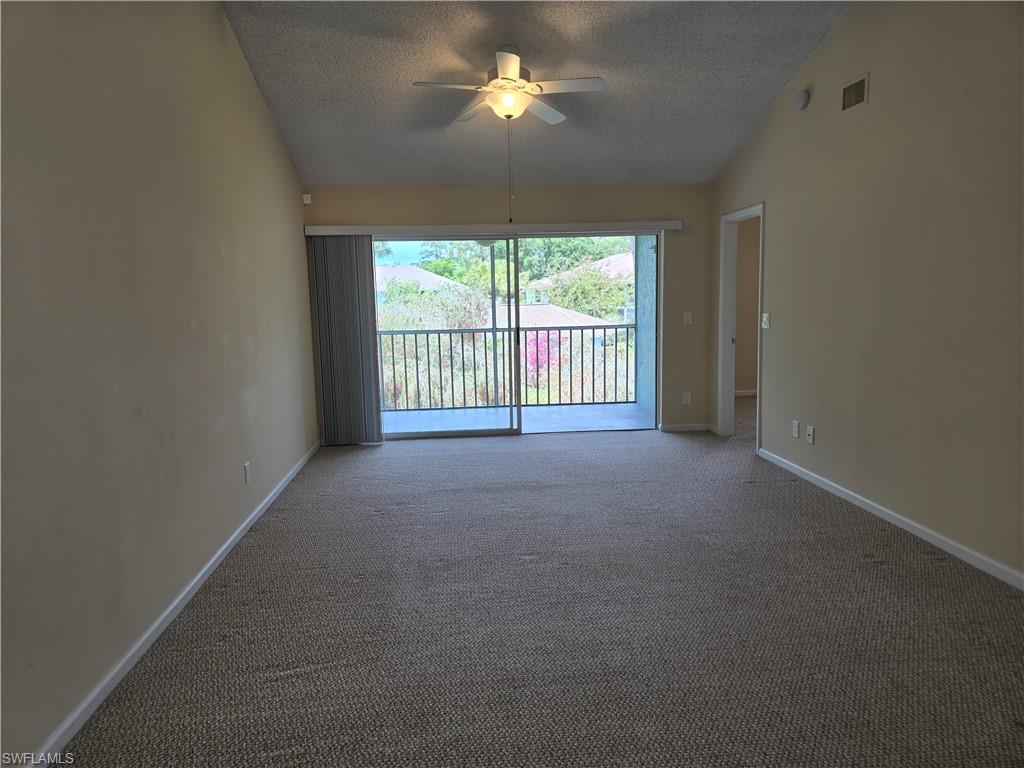 5741 Whitaker Road, Unit D203 Naples, FL 34112 - Photo 3 of 30 a view of empty room with a ceiling fan