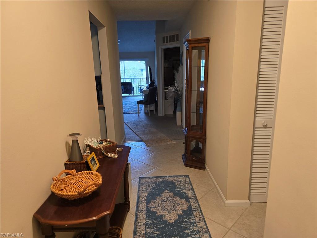 5741 Whitaker Road, Unit D203 Naples, FL 34112 - Photo 3 of 21 Entry way featuring baseboards and light tile patterned floors