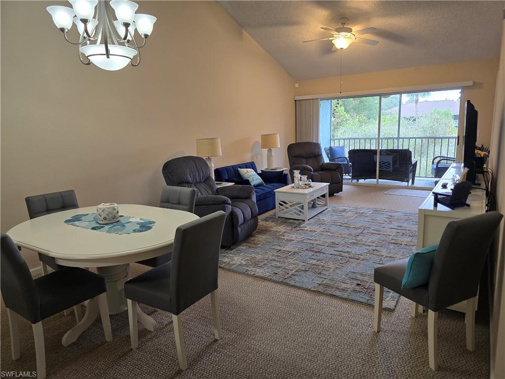5741 Whitaker Road, Unit D203 Naples, FL 34112 - Photo 7 of 21 Dining room featuring carpet floors, hanging lights, and ceiling fan. Unit is being rented unfurnished