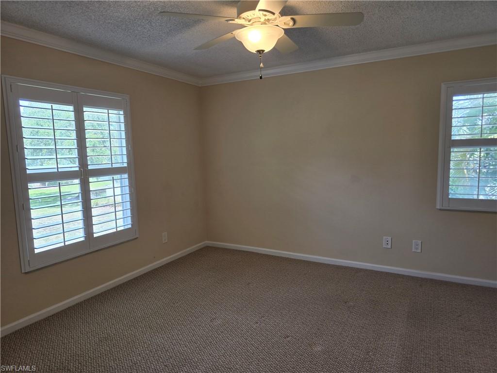 5741 Whitaker Road, Unit D203 Naples, FL 34112 - Photo 9 of 30 an empty room with a window