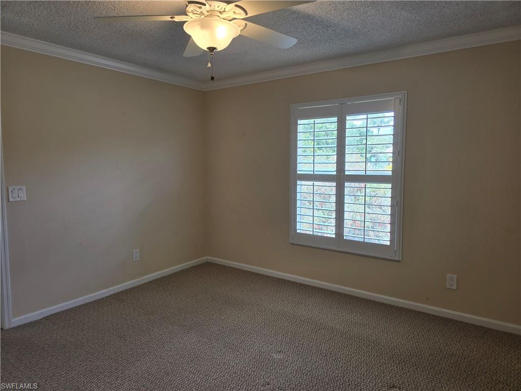 5741 Whitaker Road, Unit D203 Naples, FL 34112 - Photo 10 of 30 an empty room with a window