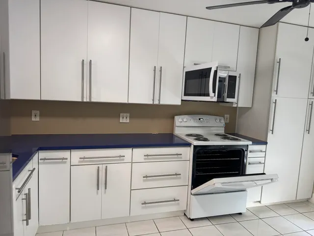 a kitchen with stainless steel appliances a stove a microwave and a sink