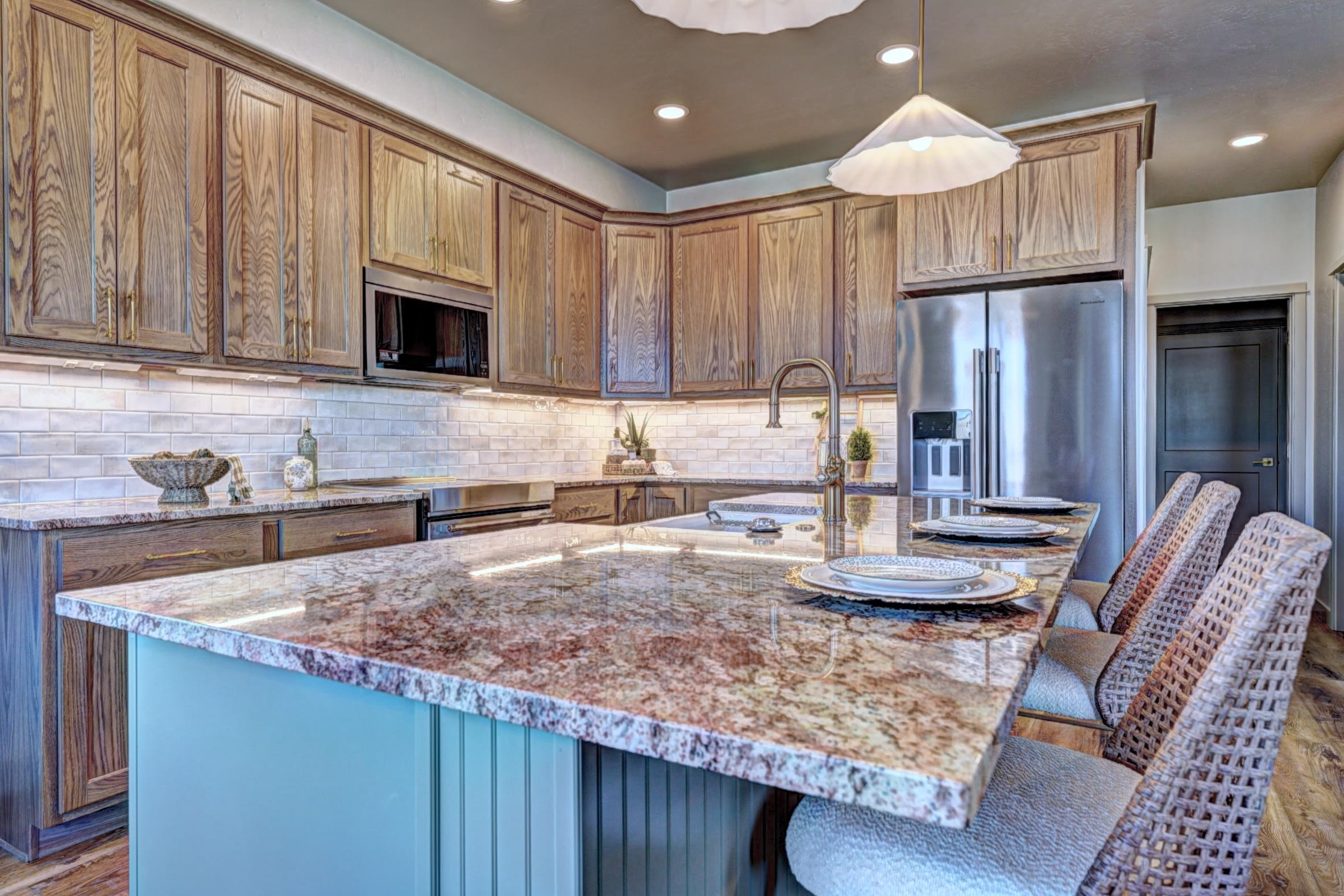 1985 Tomochic Drive Fruita, CO 81521 - Photo 11 of 42 a kitchen with kitchen island granite countertop wooden cabinets a sink and stainless steel appliances