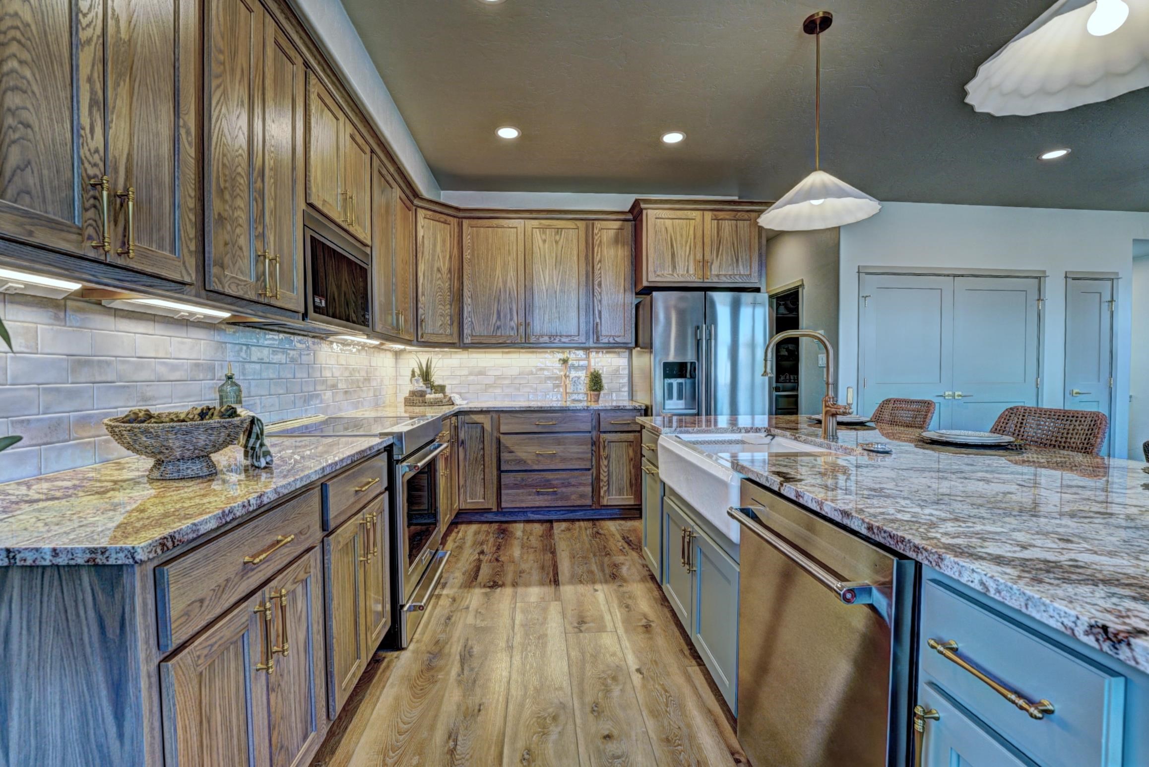 1985 Tomochic Drive Fruita, CO 81521 - Photo 14 of 42 a kitchen with stainless steel appliances granite countertop wooden cabinets a sink dishwasher a stove and a refrigerator