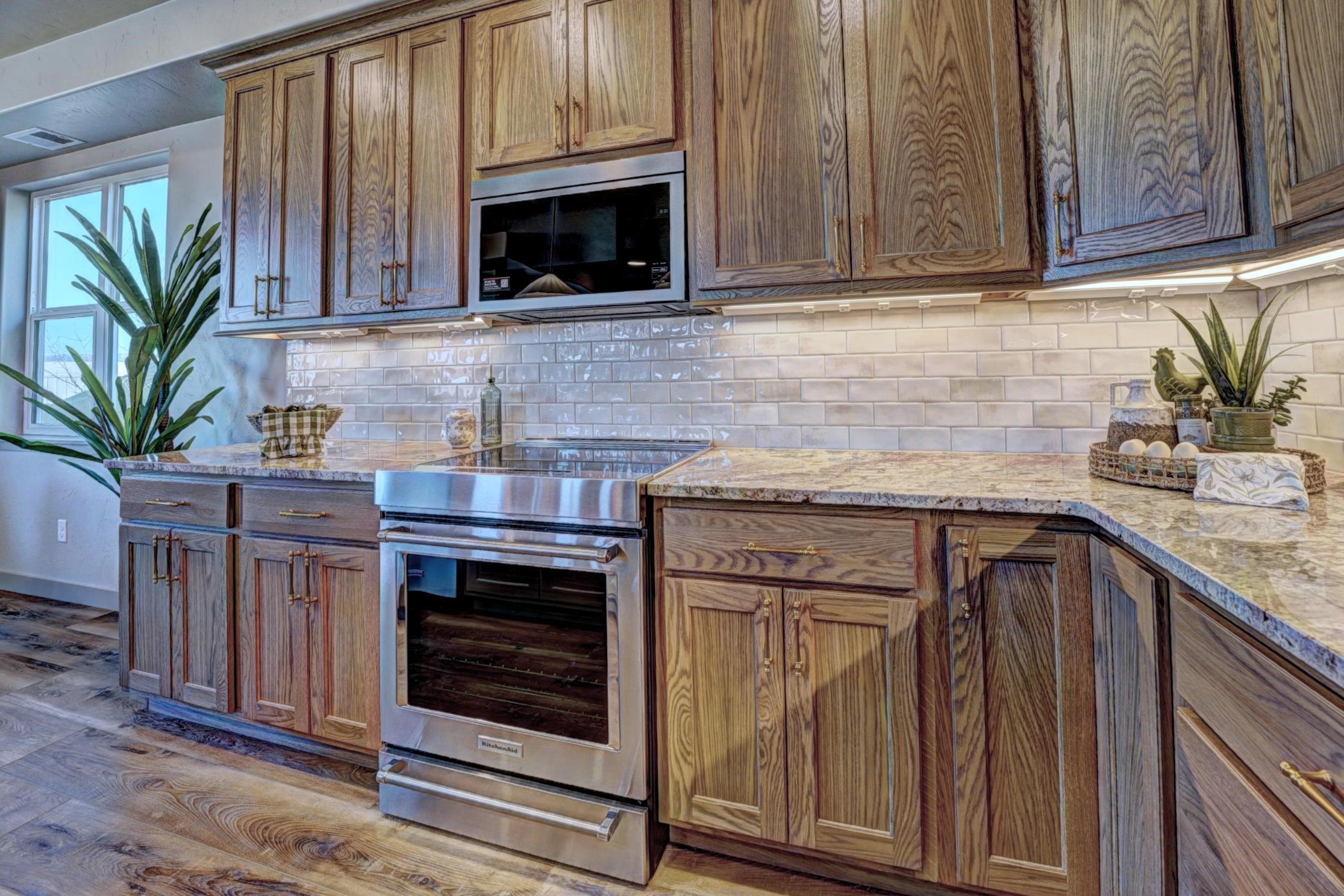 1985 Tomochic Drive Fruita, CO 81521 - Photo 16 of 42 a kitchen with granite countertop a stove a microwave a sink and cabinets