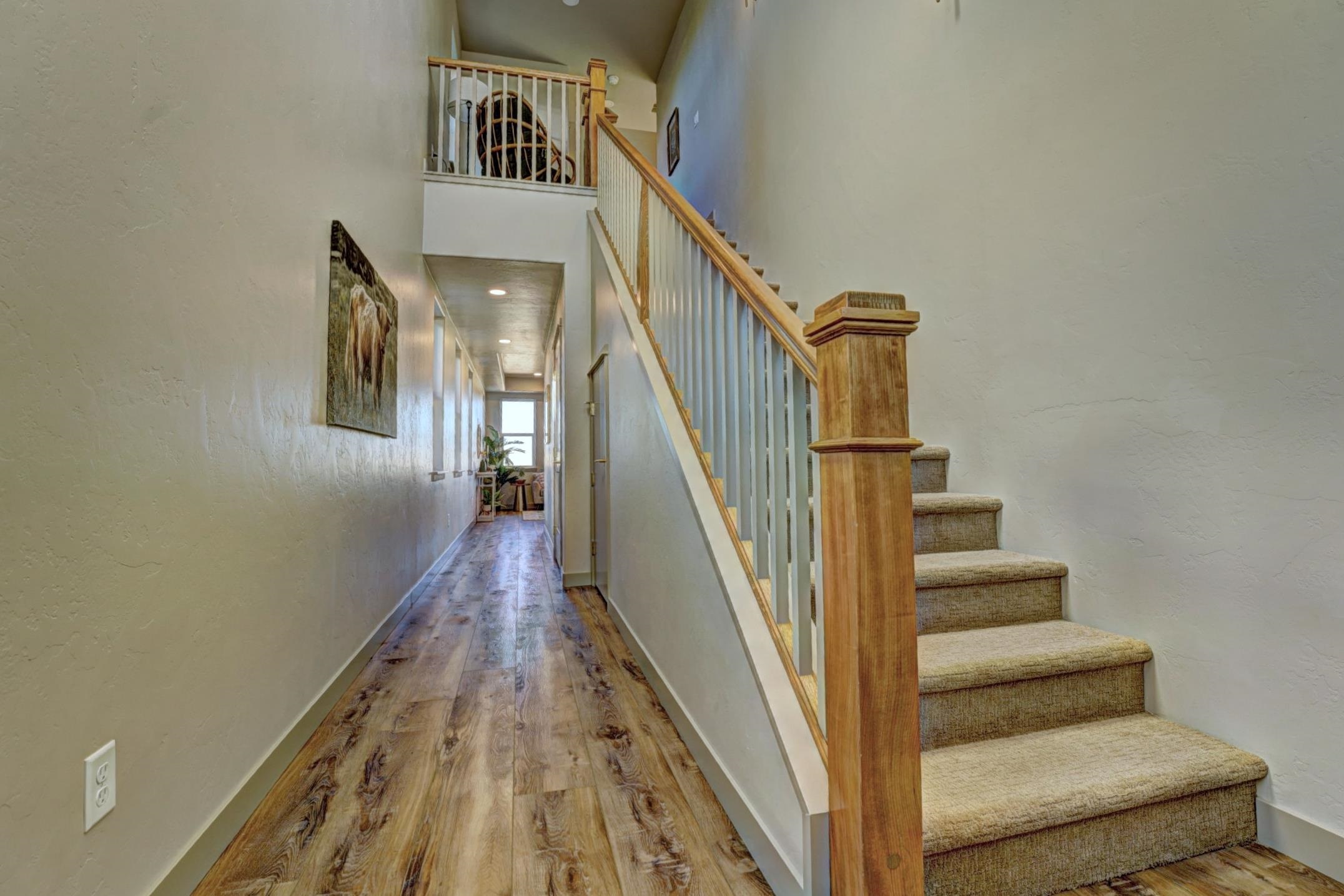 1985 Tomochic Drive Fruita, CO 81521 - Photo 3 of 42 a view of staircase with wooden floor and white walls