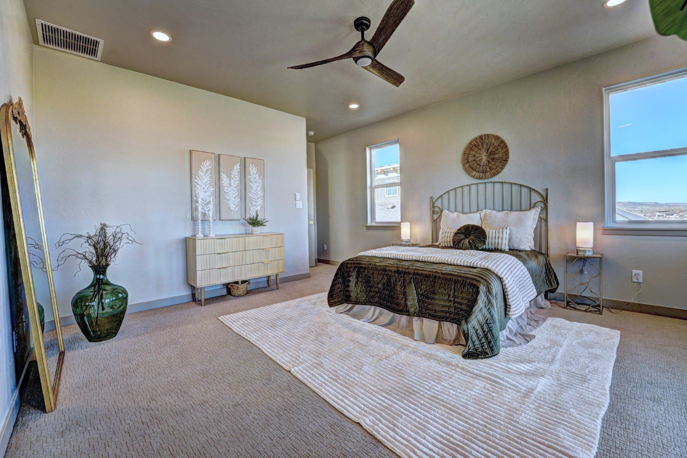 1985 Tomochic Drive Fruita, CO 81521 - Photo 35 of 42 a bedroom with a bed and a chandelier