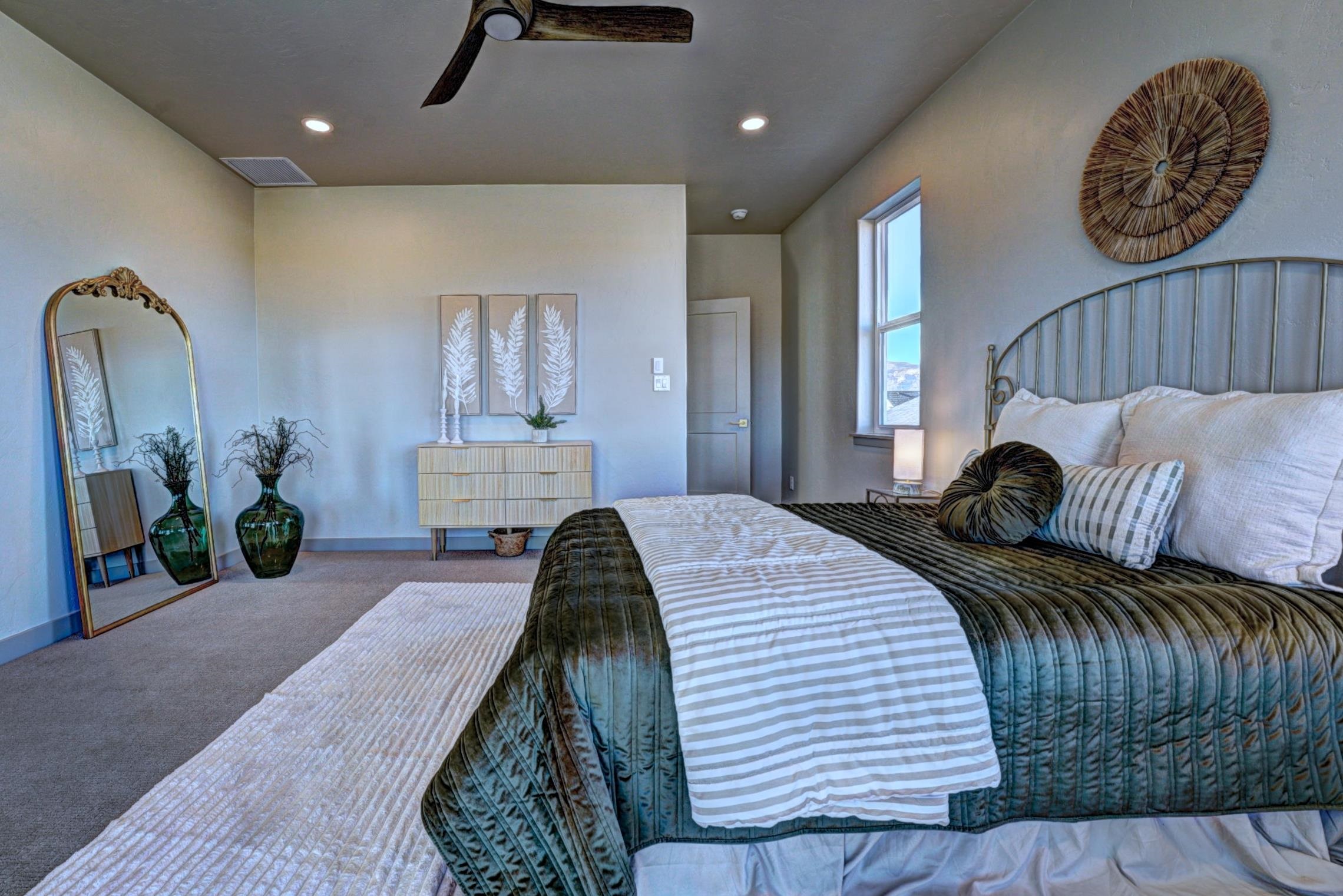 1985 Tomochic Drive Fruita, CO 81521 - Photo 36 of 42 a bedroom with a bed and a chandelier