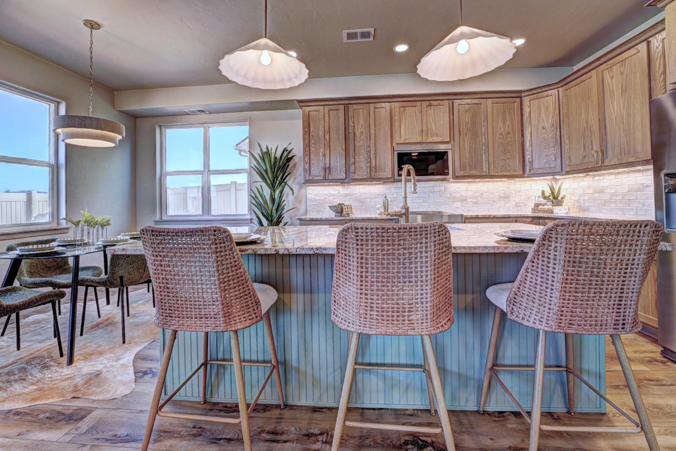 1985 Tomochic Drive Fruita, CO 81521 - Photo 9 of 42 an open kitchen with granite countertop wooden cabinets dining table and chairs