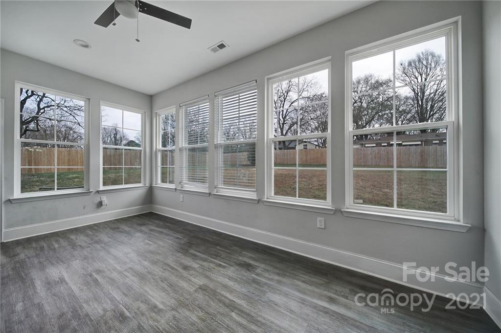 5040 Cheviot Road Charlotte, NC 28269 - Photo 12 of 27 a view of an empty room with a window and wooden floor