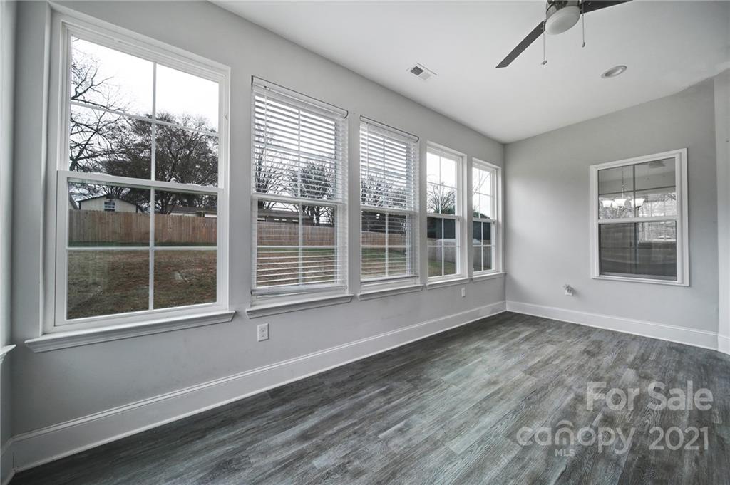 5040 Cheviot Road Charlotte, NC 28269 - Photo 13 of 27 a view of an empty room with a window and wooden floor