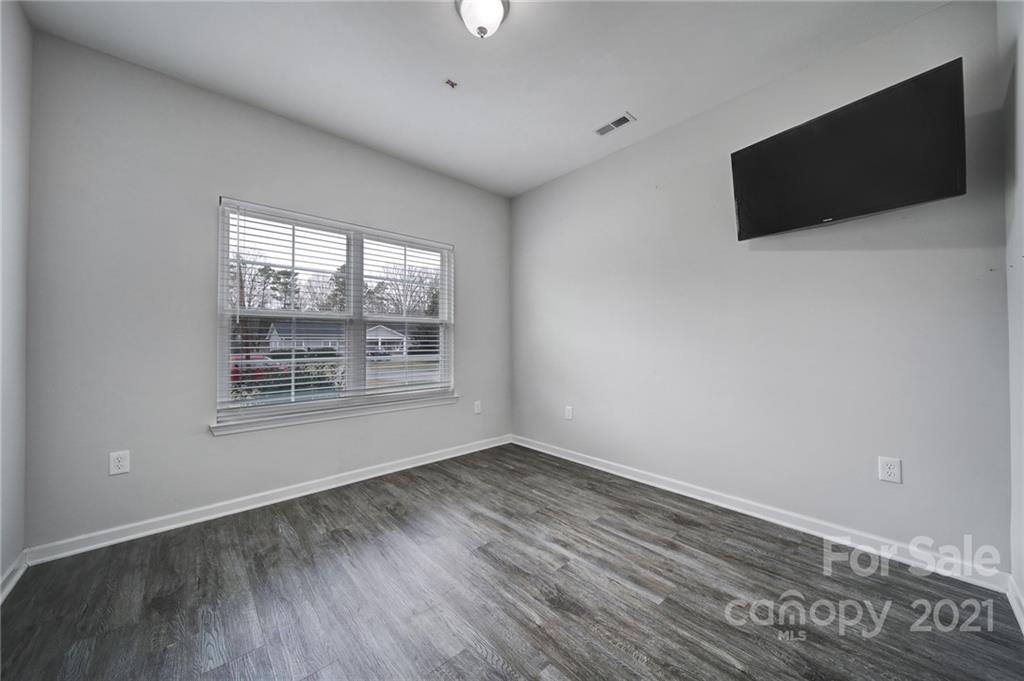 5040 Cheviot Road Charlotte, NC 28269 - Photo 18 of 27 wooden floor in an empty room with a window