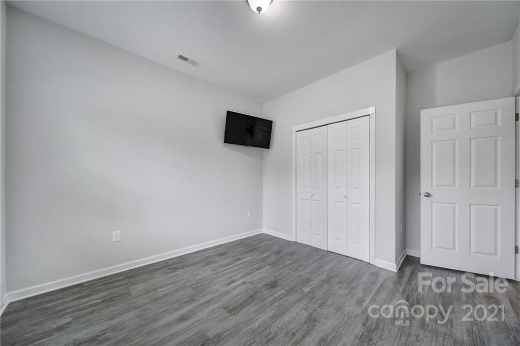 5040 Cheviot Road Charlotte, NC 28269 - Photo 20 of 27 a view of an empty room with wooden floor and a window
