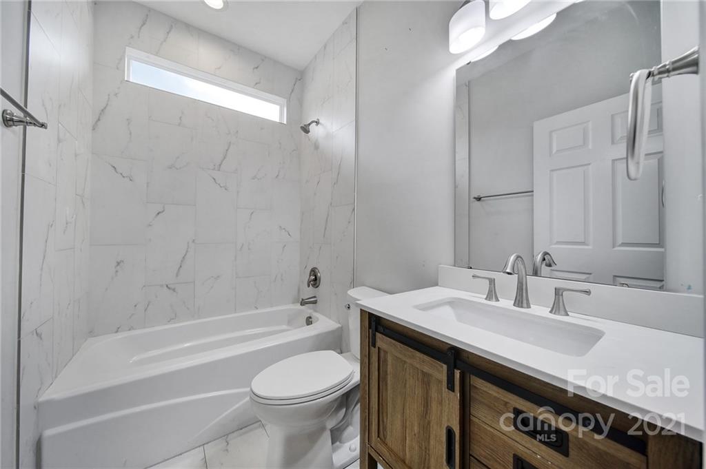 5040 Cheviot Road Charlotte, NC 28269 - Photo 23 of 27 a bathroom with a sink a toilet and shower