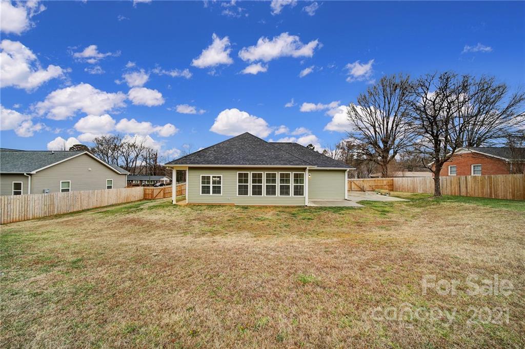 5040 Cheviot Road Charlotte, NC 28269 - Photo 26 of 27 a view of a yard in front of a house with a large tree