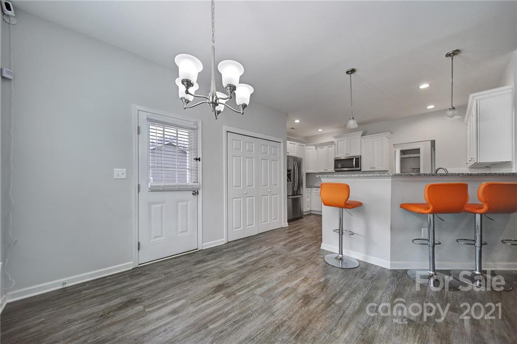 5040 Cheviot Road Charlotte, NC 28269 - Photo 6 of 27 a view of a kitchen and dining area with chandelier