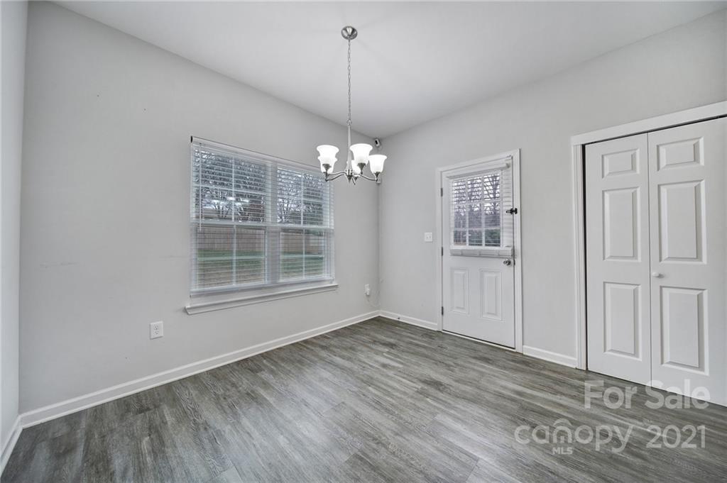 5040 Cheviot Road Charlotte, NC 28269 - Photo 8 of 27 wooden floor in an empty room with a window