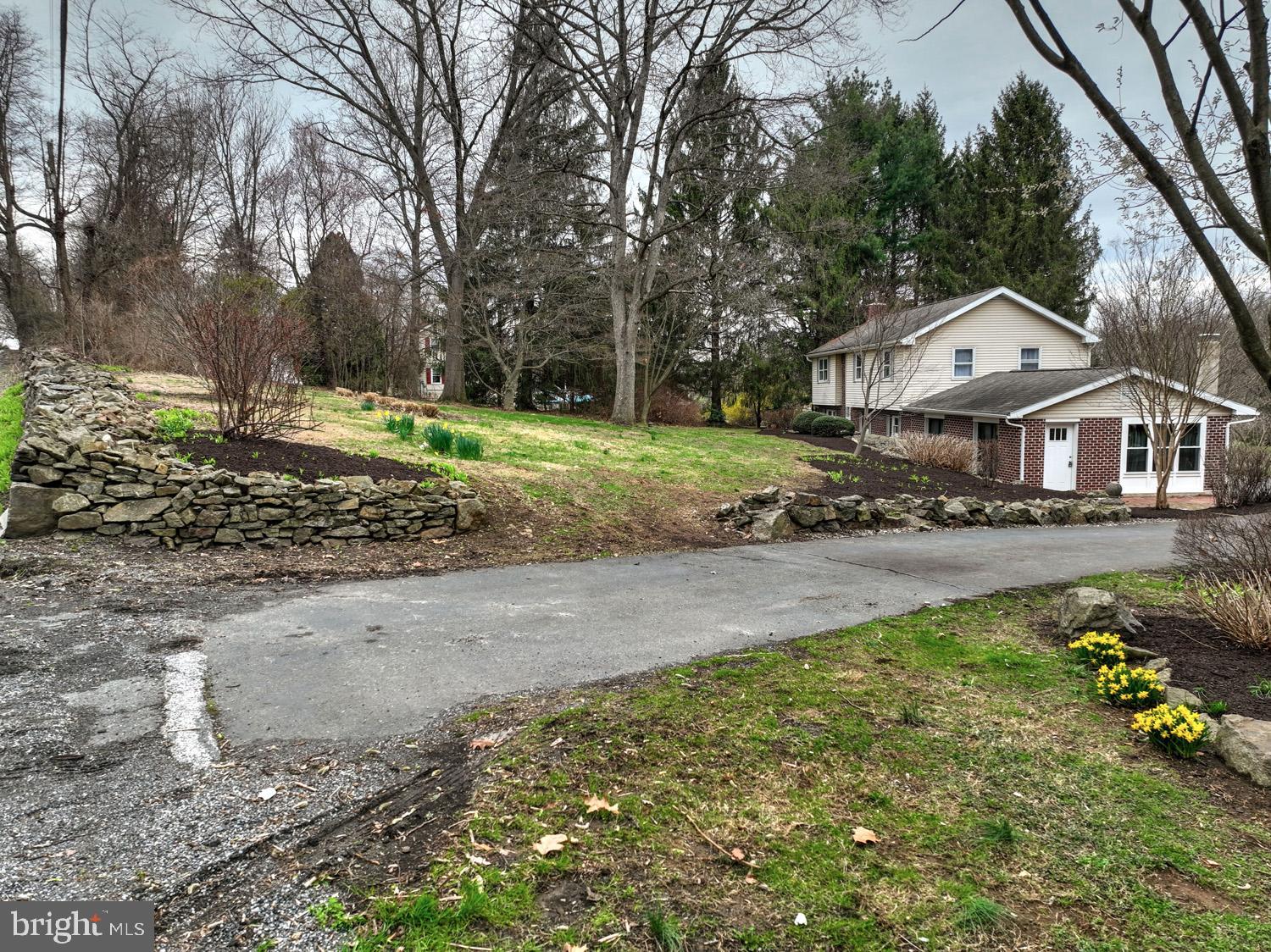 1822 Little Conestoga Road Elverson, PA 19520 - Photo 5 of 30 a front view of a house with a yard and large trees