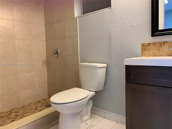 a white toilet sitting next to a bathroom sink