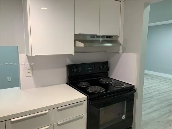 a stove top oven sitting inside of a kitchen
