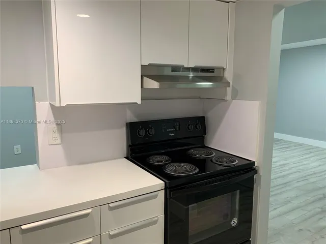 a stove top oven sitting inside of a kitchen