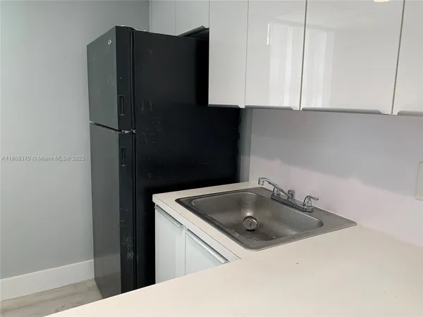 a kitchen with a sink and cabinets