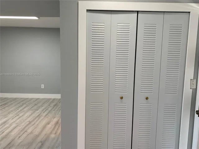 a view of a room with a white door