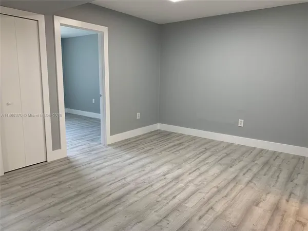 a view of room with wooden floor