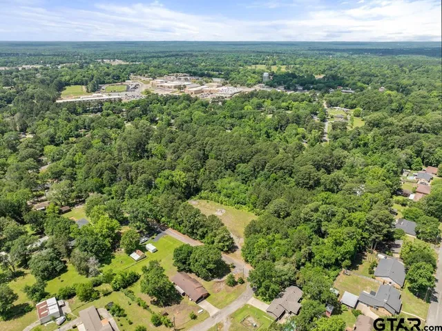 an aerial view of a houses with a yard