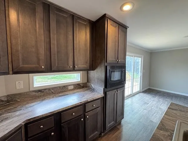 a kitchen with granite countertop wooden cabinets and a granite counter tops