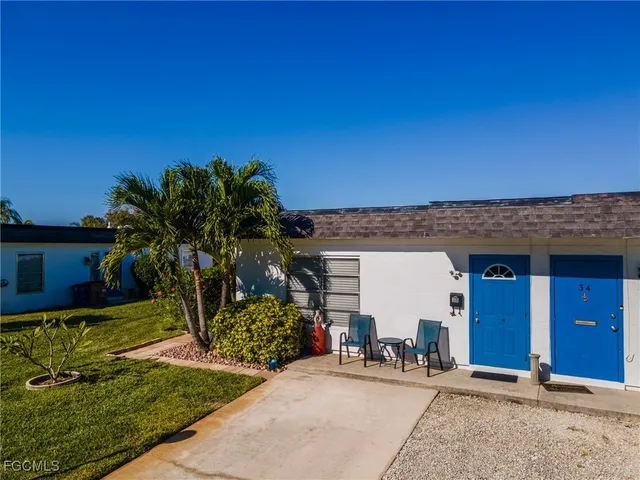 a view of a chair and table in the backyard