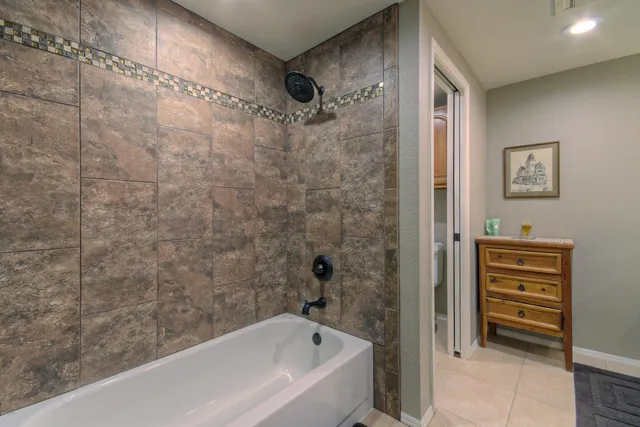 a bathroom with a bathtub and a shower