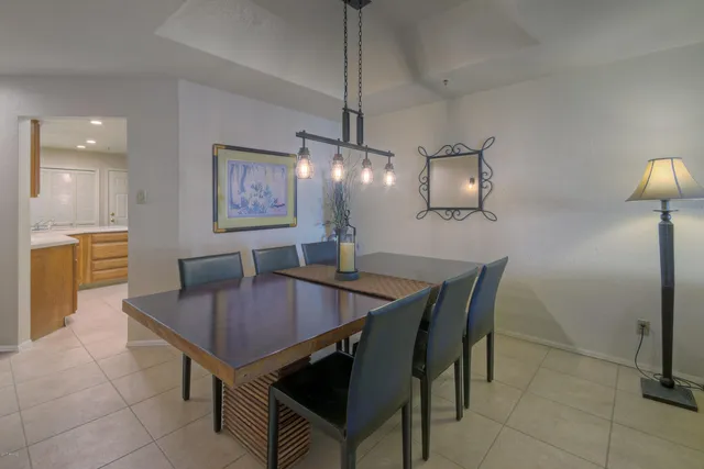 a dining room with furniture and chandelier