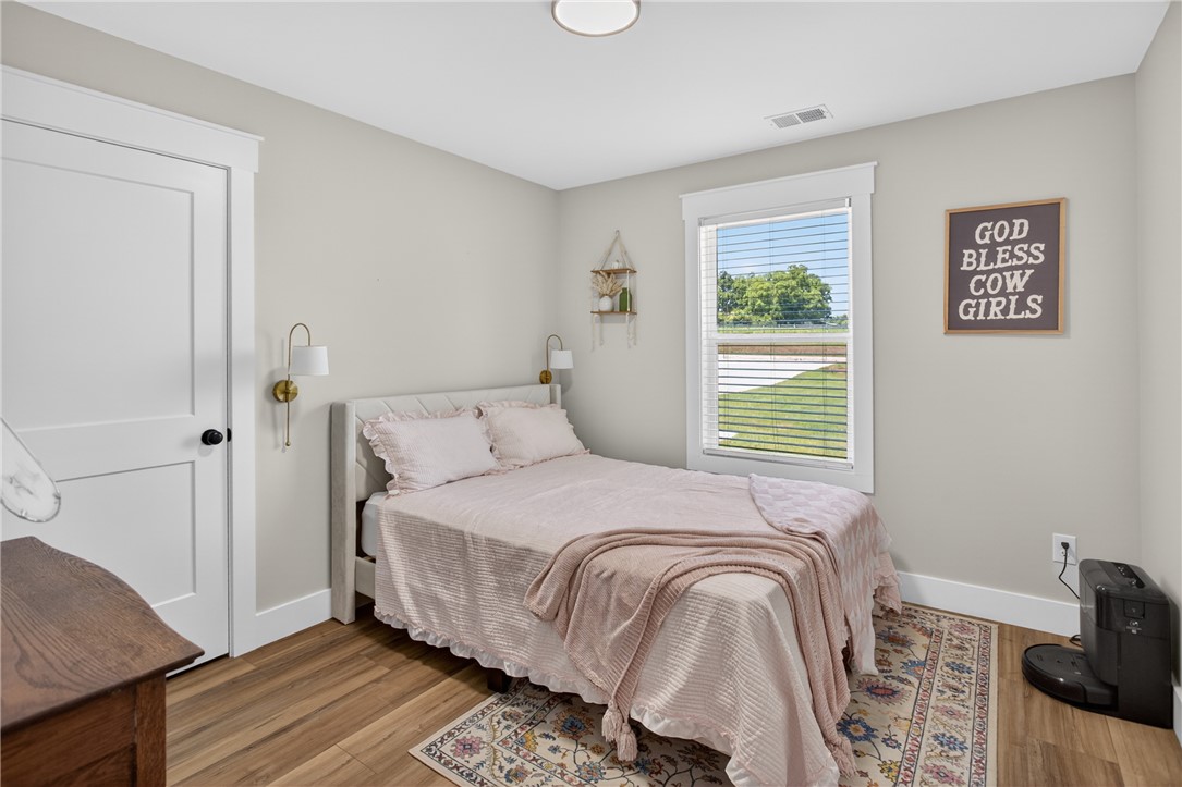 106 Bolt Road Townville, SC 29689 - Photo 18 of 33 Hardwood floors and a sun-filled window create a welcoming atmosphere in this comfortable bedroom.