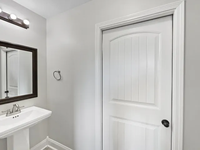 a bathroom with a mirror sink and vanity